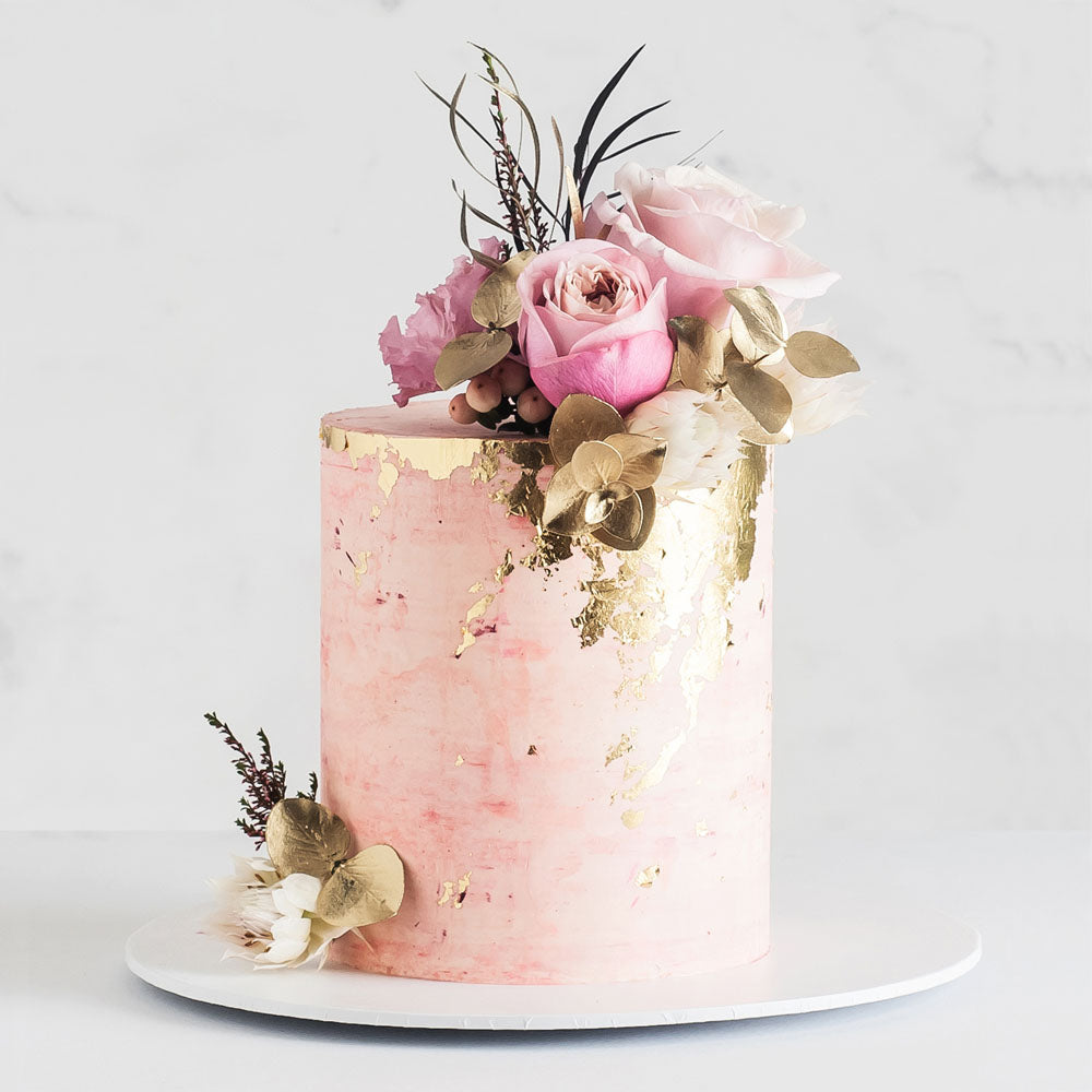 Pink rose quartz inspired buttercream cake with gold leaf and flowers