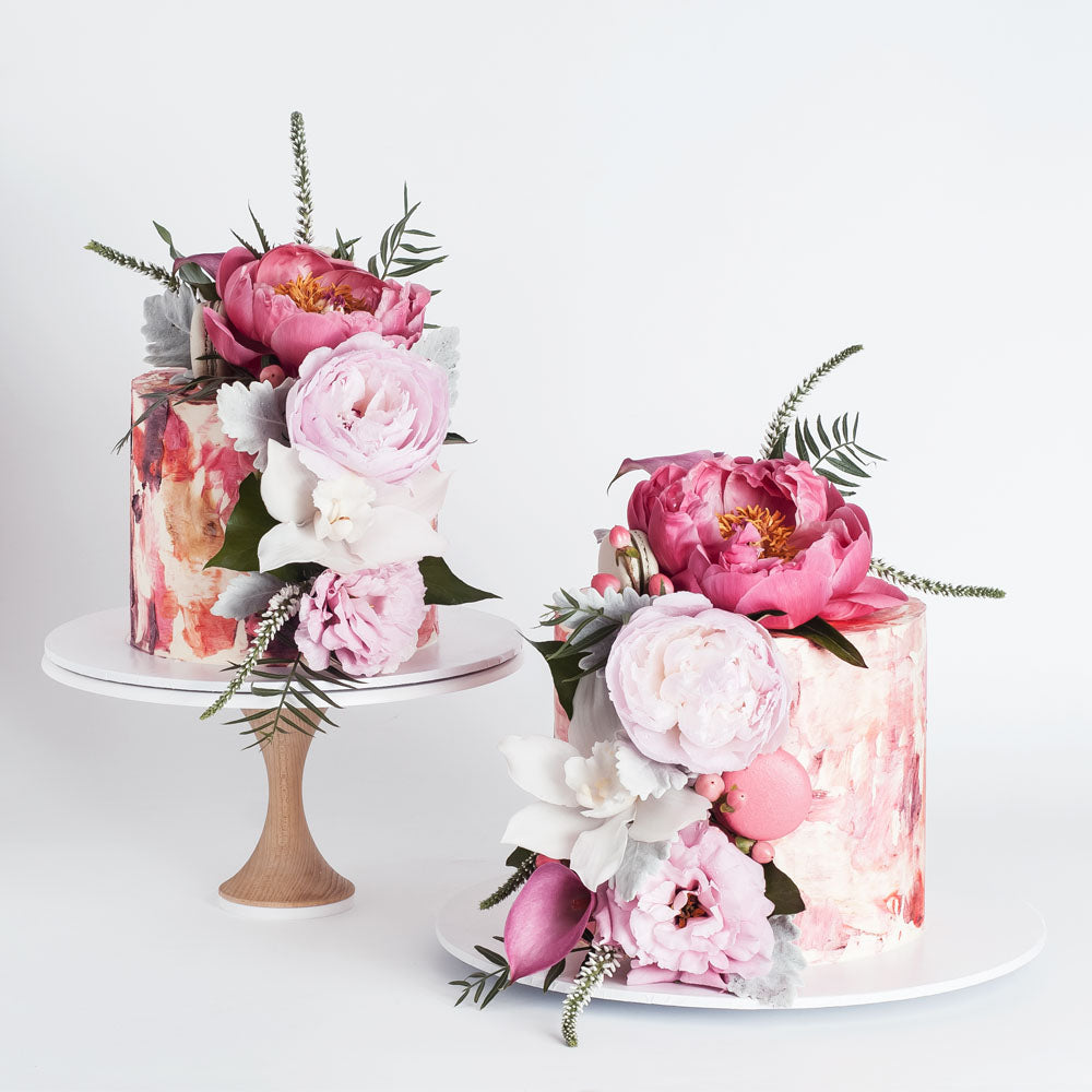 Pink watercolour buttercream cakes with flowers and macarons
